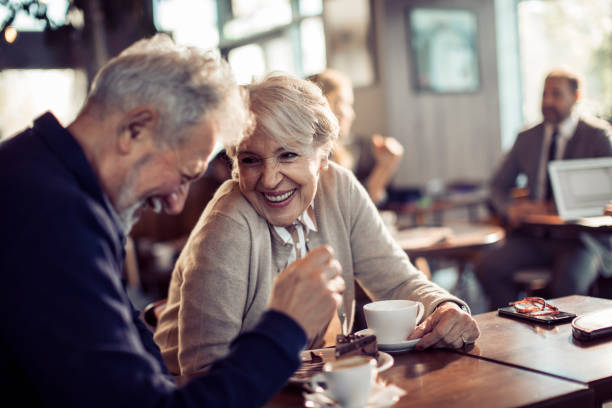 Close up of a happy senior couple having coffee in a cafe