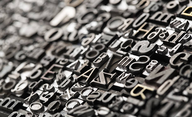 Letterpress background, close up of many old, random metal letters with copy space